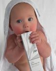 Happy baby after gentle massage using Pod Organics Vitamin E Massage Oil
