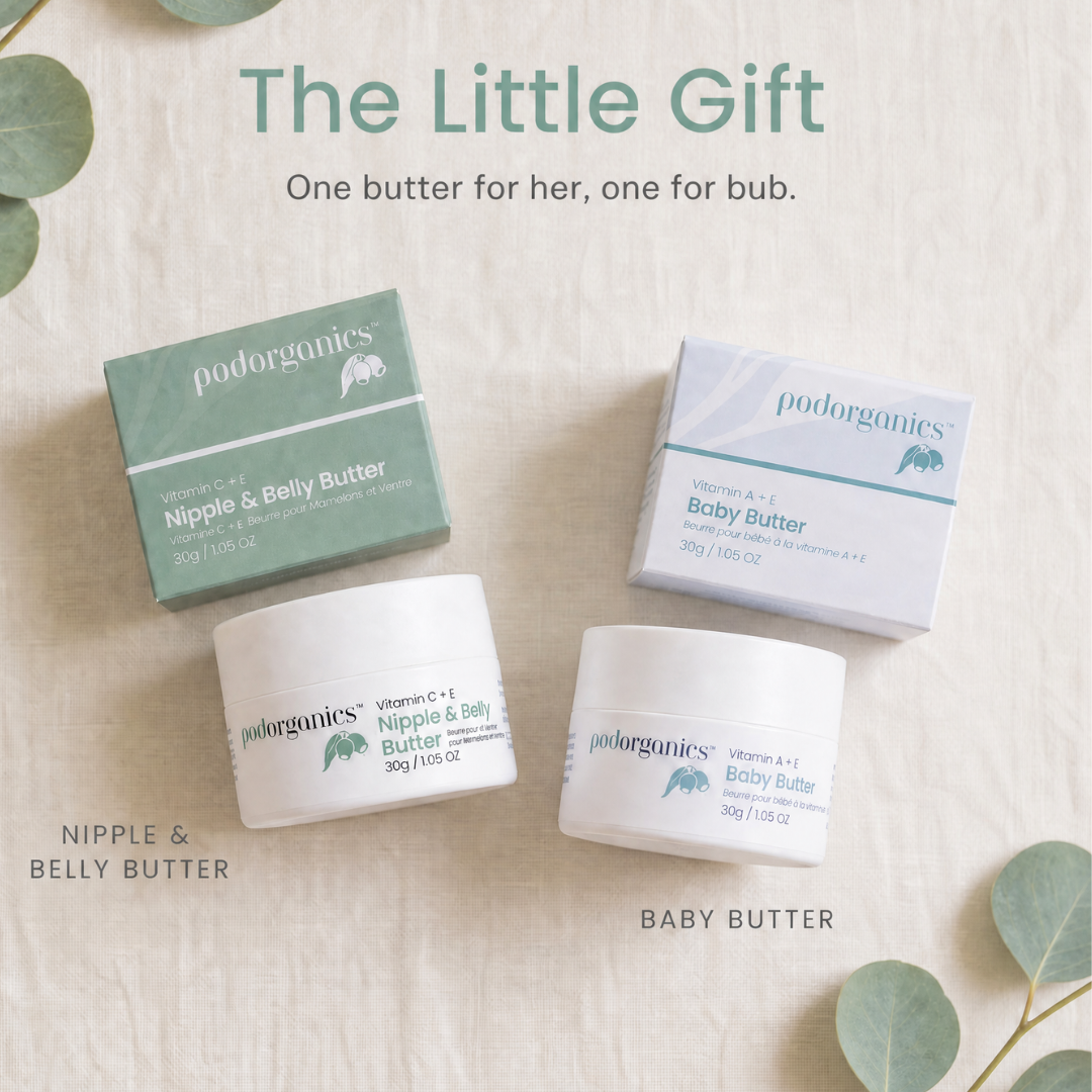 Two Pod organics baby butters, Nipple & Belly Butter and Baby Butter, displayed with their respective boxes on a textured beige linen background with decorative eucalyptus leaves. The text at the top reads 'The Little Gift' and 'One butter for her, one for tub.