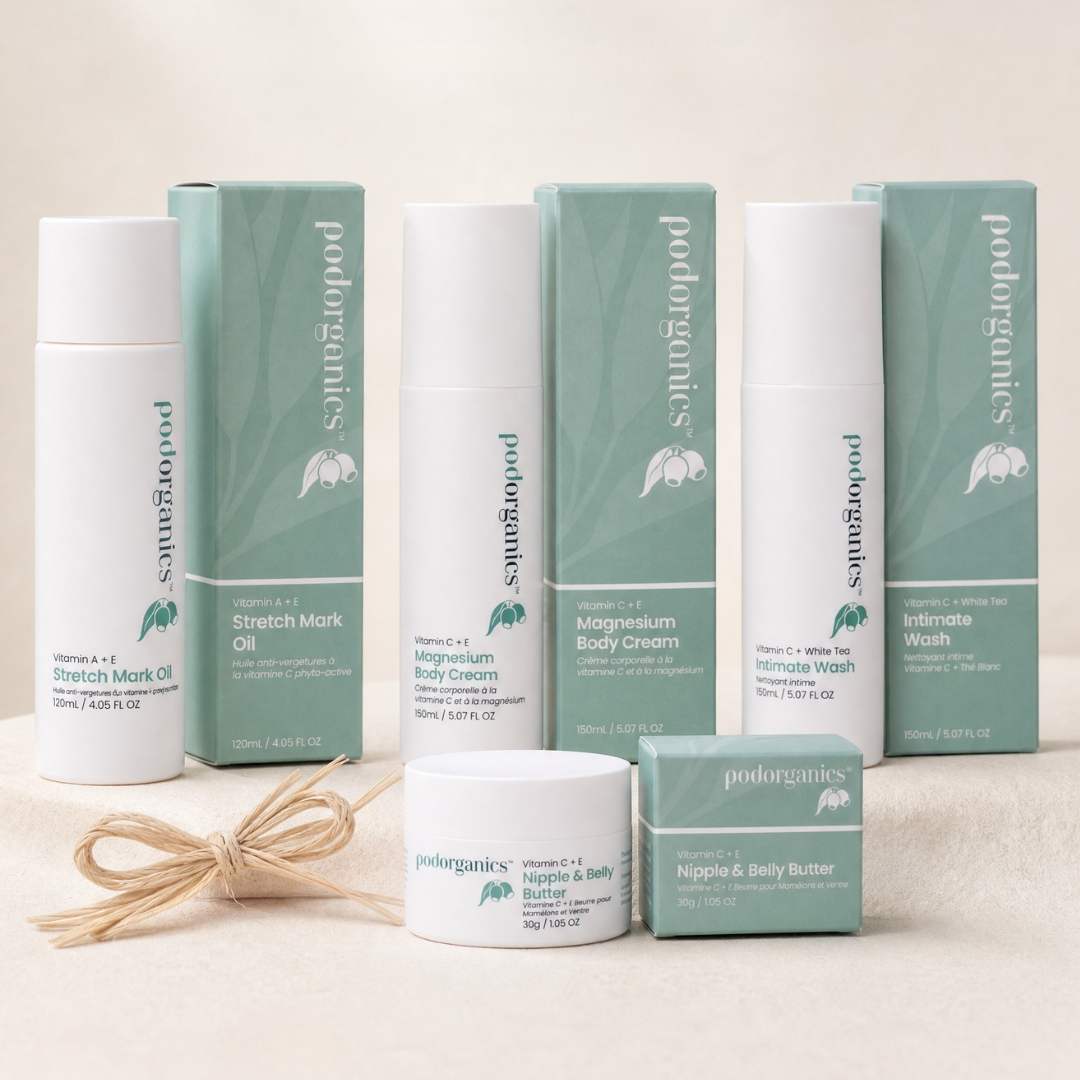 A collection of pod organics natural body care products arranged on a light beige fabric background, including Stretch Mark Oil, Stretch Mark Body Cream, Magnesium Body Cream, Intimate Wash, Nigga & Body Butter, and their matching green and white boxes, with a small bundle of twine in the foreground.